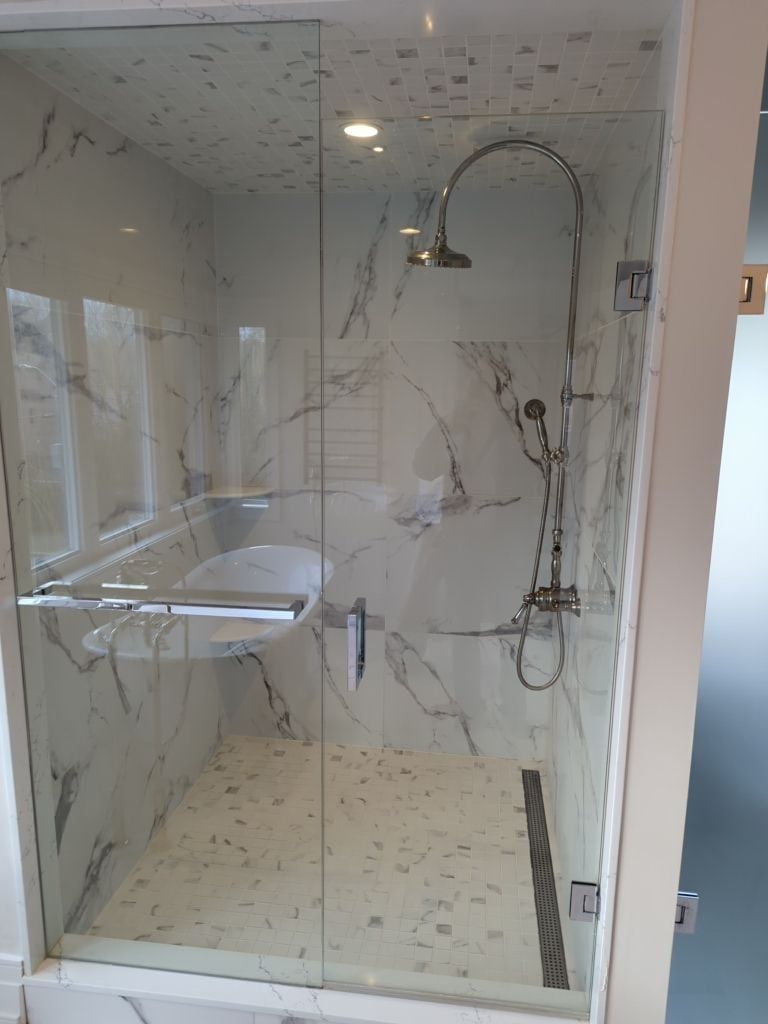 Glass shower with marble look wall tile, a mosaic ceiling, an exposed rain shower set and a linear drain