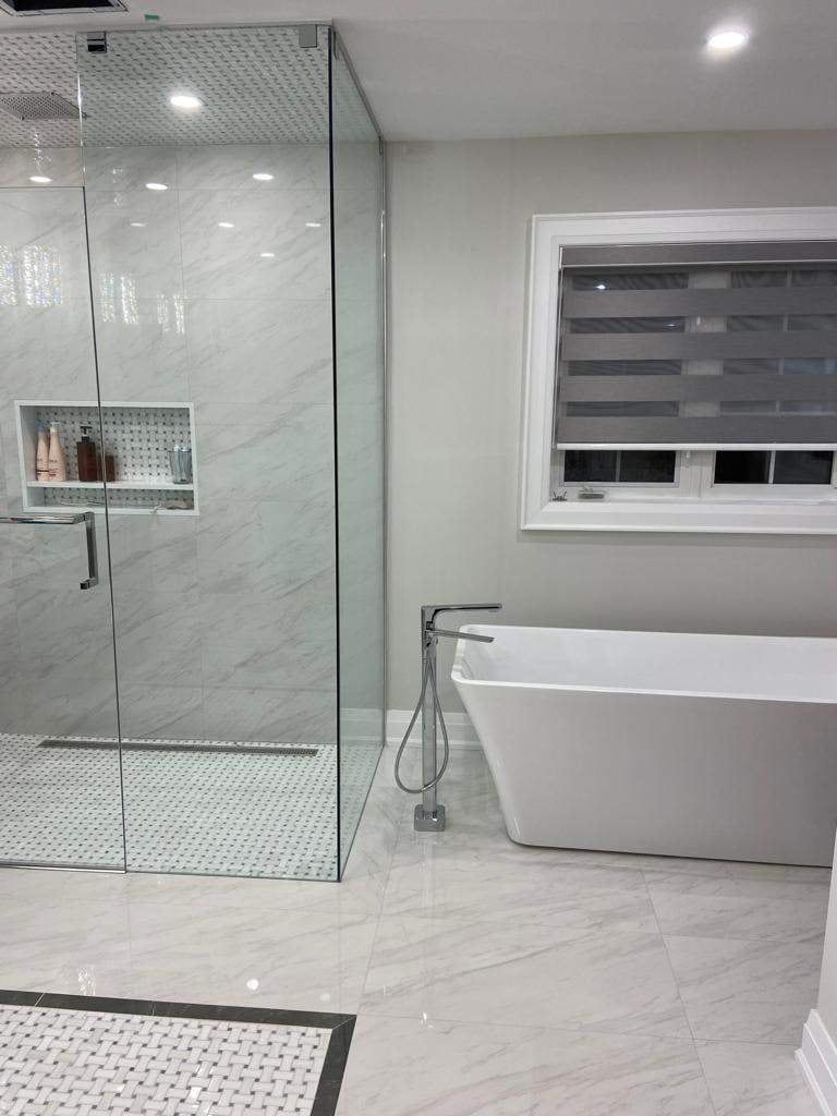 Ensuite with glass walk-in shower, basketweave mosaic floor, freestanding tub and floor-mounted filler
