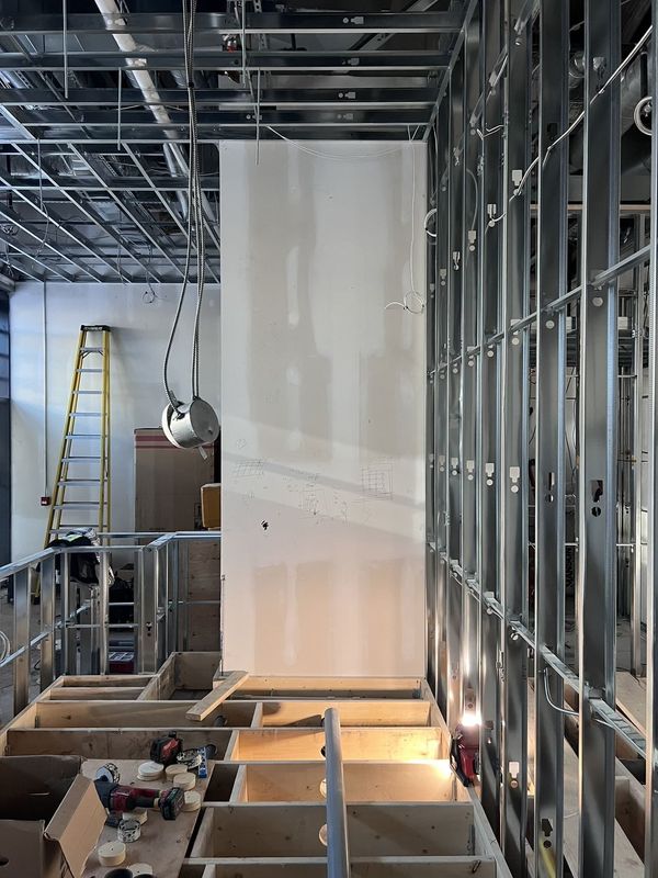 A counter base framed in wood beside steel stud walls