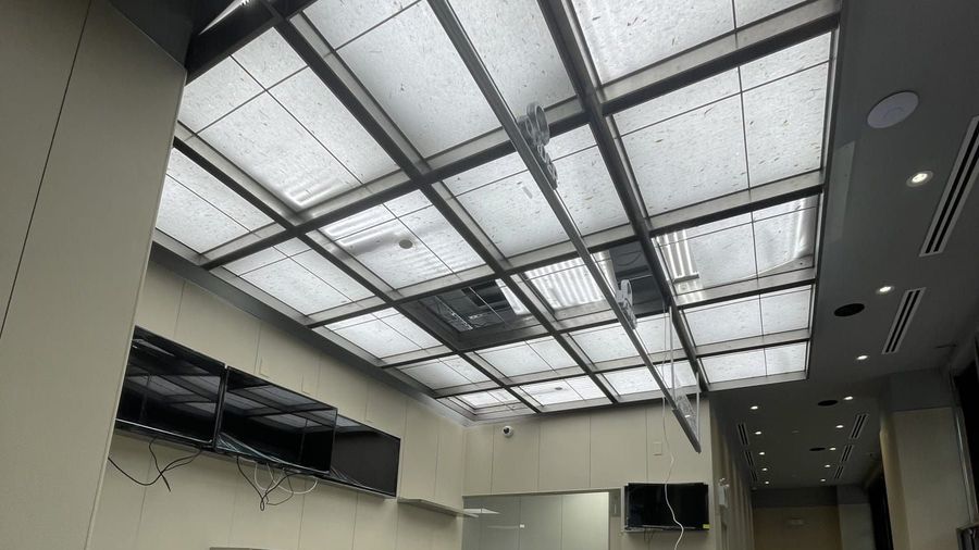 Finished interior with a lit paper ceiling