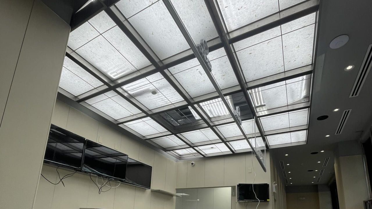 Finished interior with a lit paper ceiling
